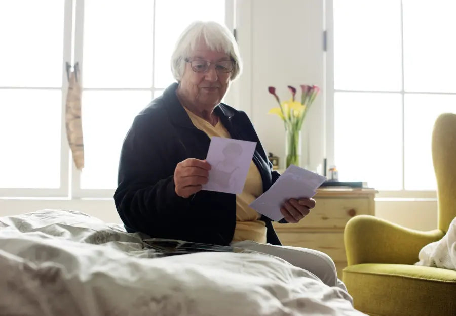 Elderly woman with dementia daily routine looking at photos