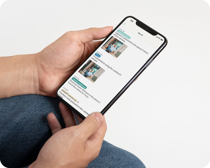 A person using the JubileeTV app to remotely monitor their elderly parents.