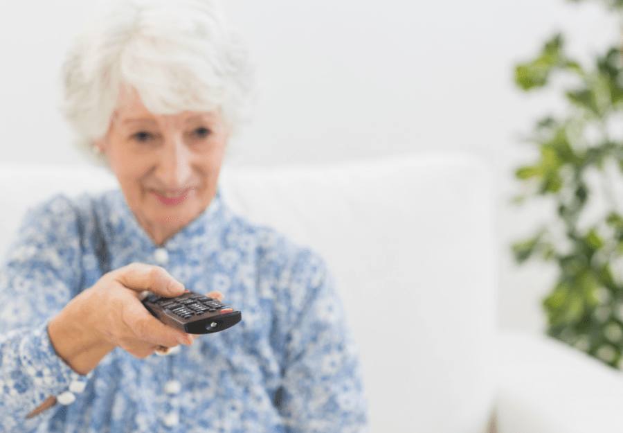 elderly woman watching streaming on her TV for seniors