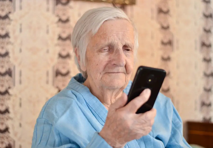 elderly woman looking at smartphone setup for seniors