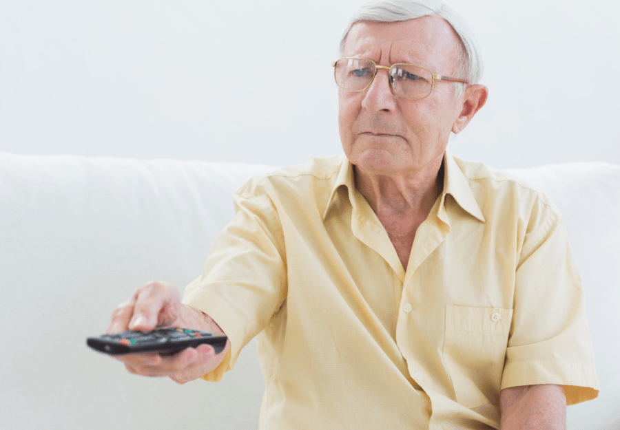 A man with dementia is using a simple remote control