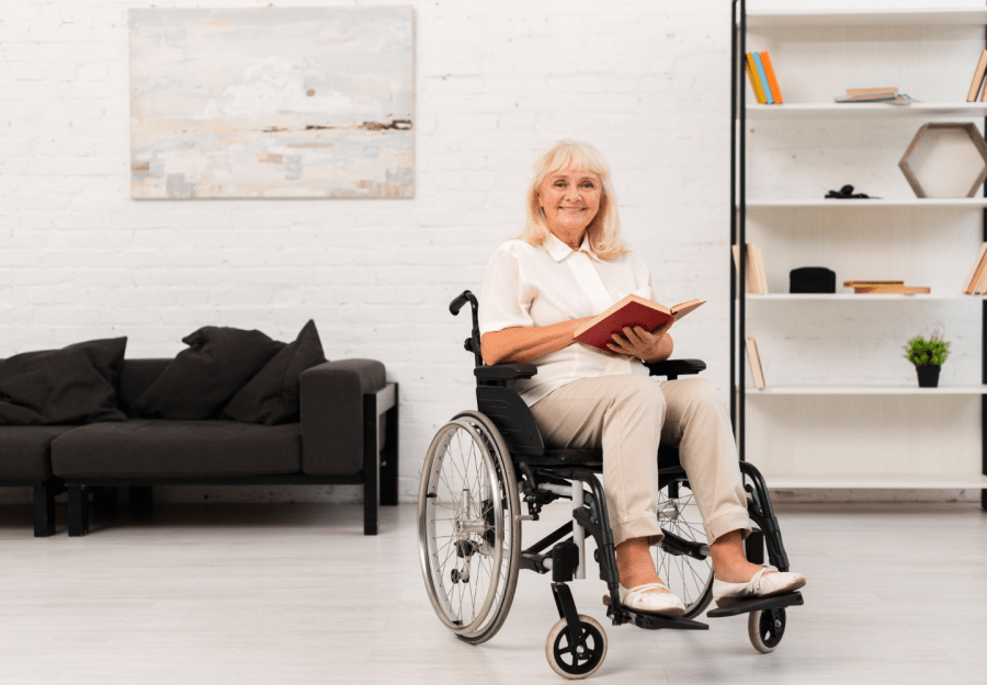 elderly woman in wheelchair reading a book