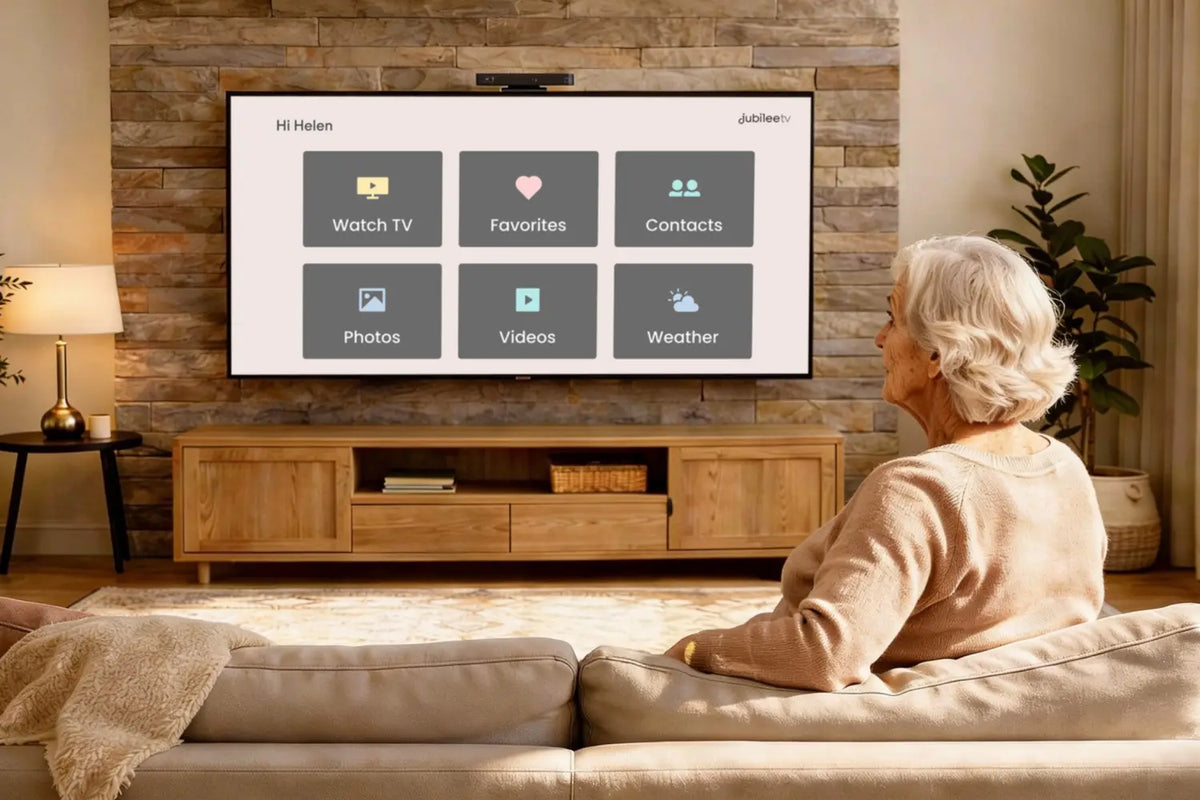 An elderly woman is watching television using jubileetv to simplify the experience