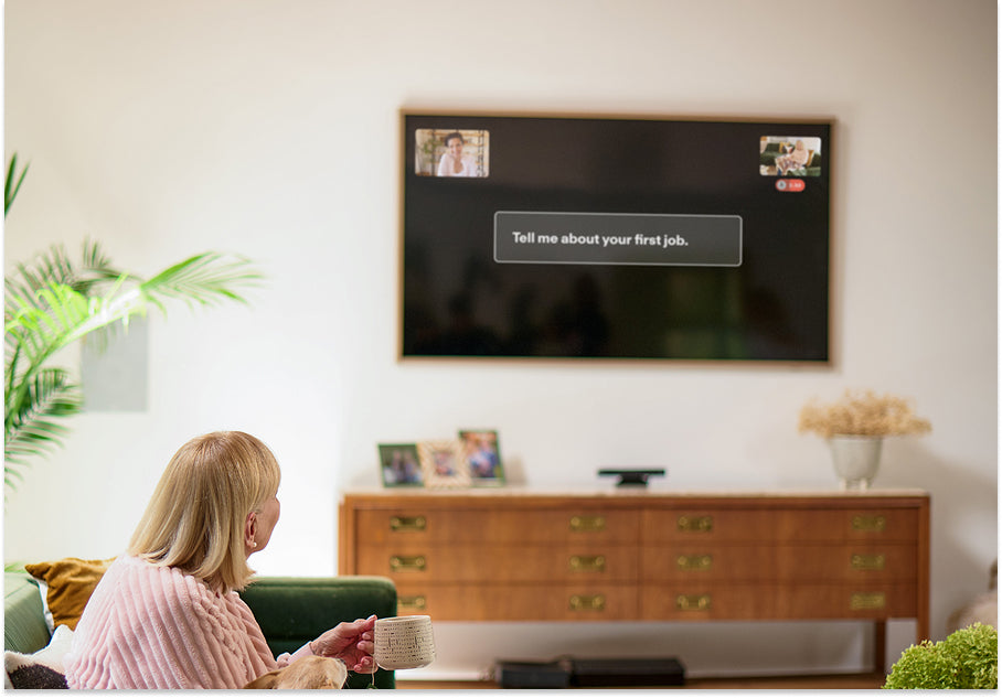 An elderly woman sees a prompt on her tv to share a memory that will be recorded