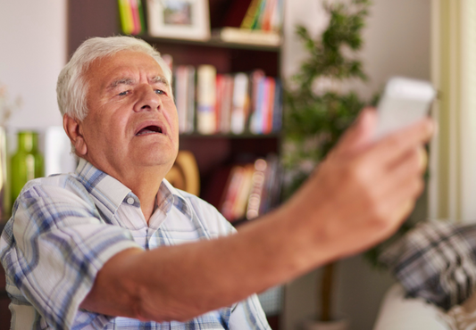 elderly struggling with technology to see smartphone