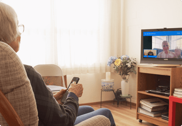 elderly woman video calling on TV