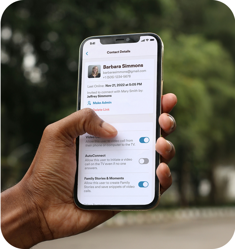 Hand holding a smartphone with a contact app open, displaying contact details and permissions for them within the Jubilee app.