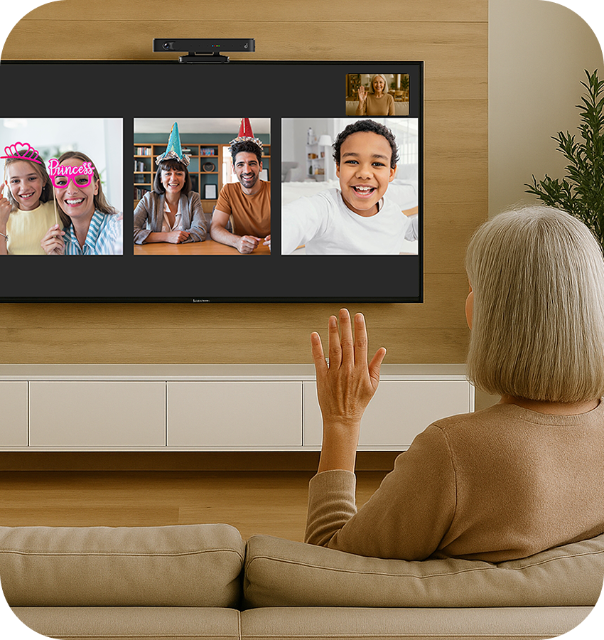 Person on a video call with five others on a large screen in a living room.