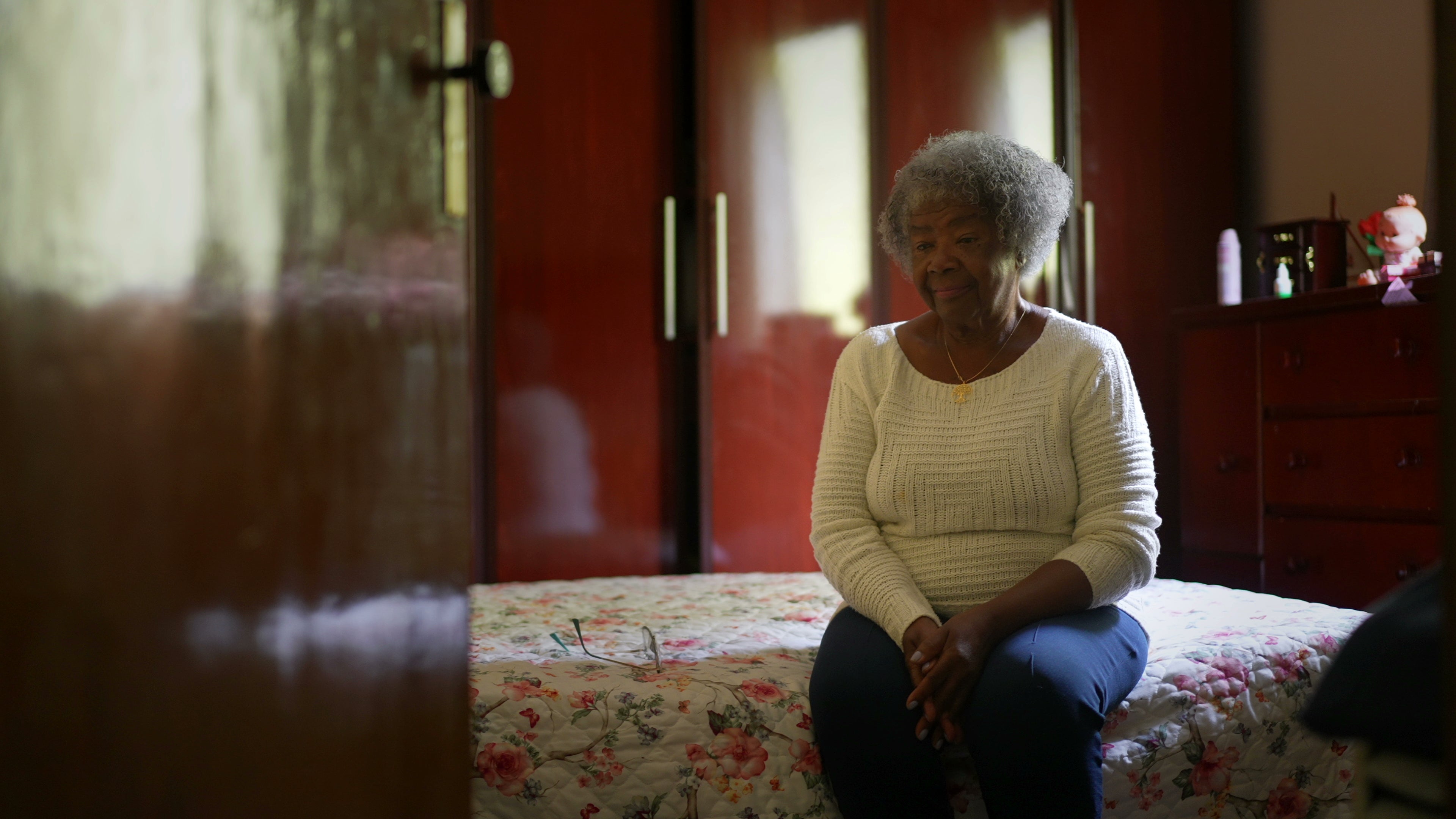 elderly woman sitting on her bed remotely monitored