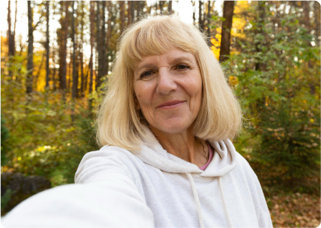 woman taking selfie for video call with elderly mother
