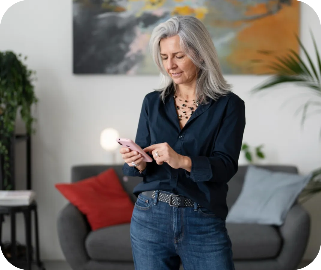 Woman using a smartphone in a living room setting